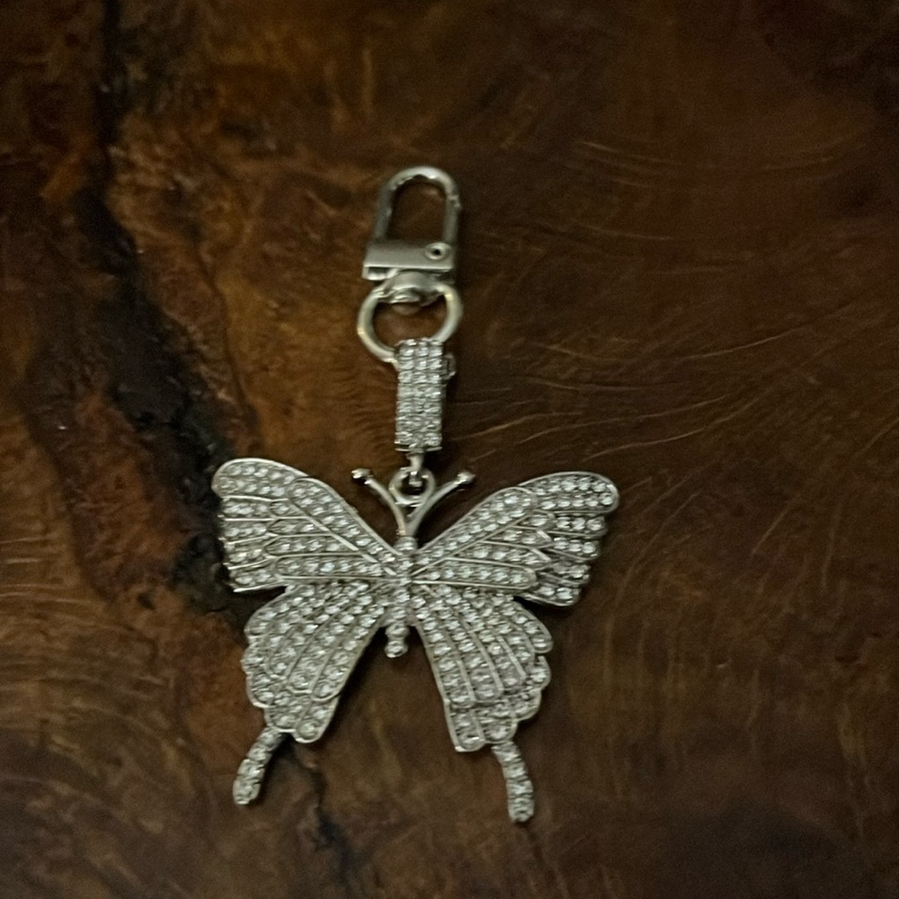 Rhinestone butterfly bag charm in silver tone